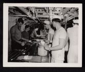Shipboard Life. Men receiving food in galley